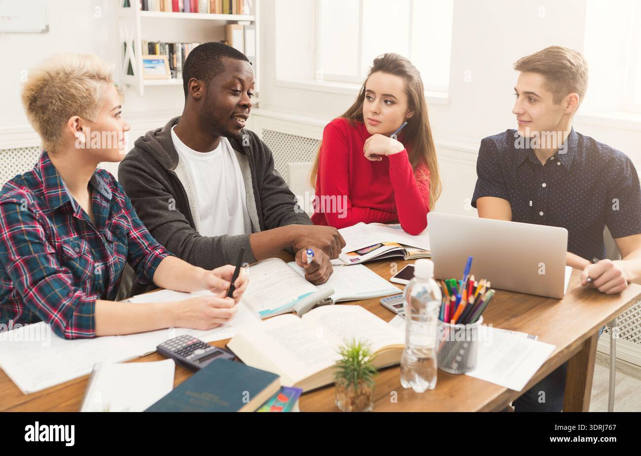 Students Collaborate on a Project During Their Study Session in a Bright Classroom Stock Photo