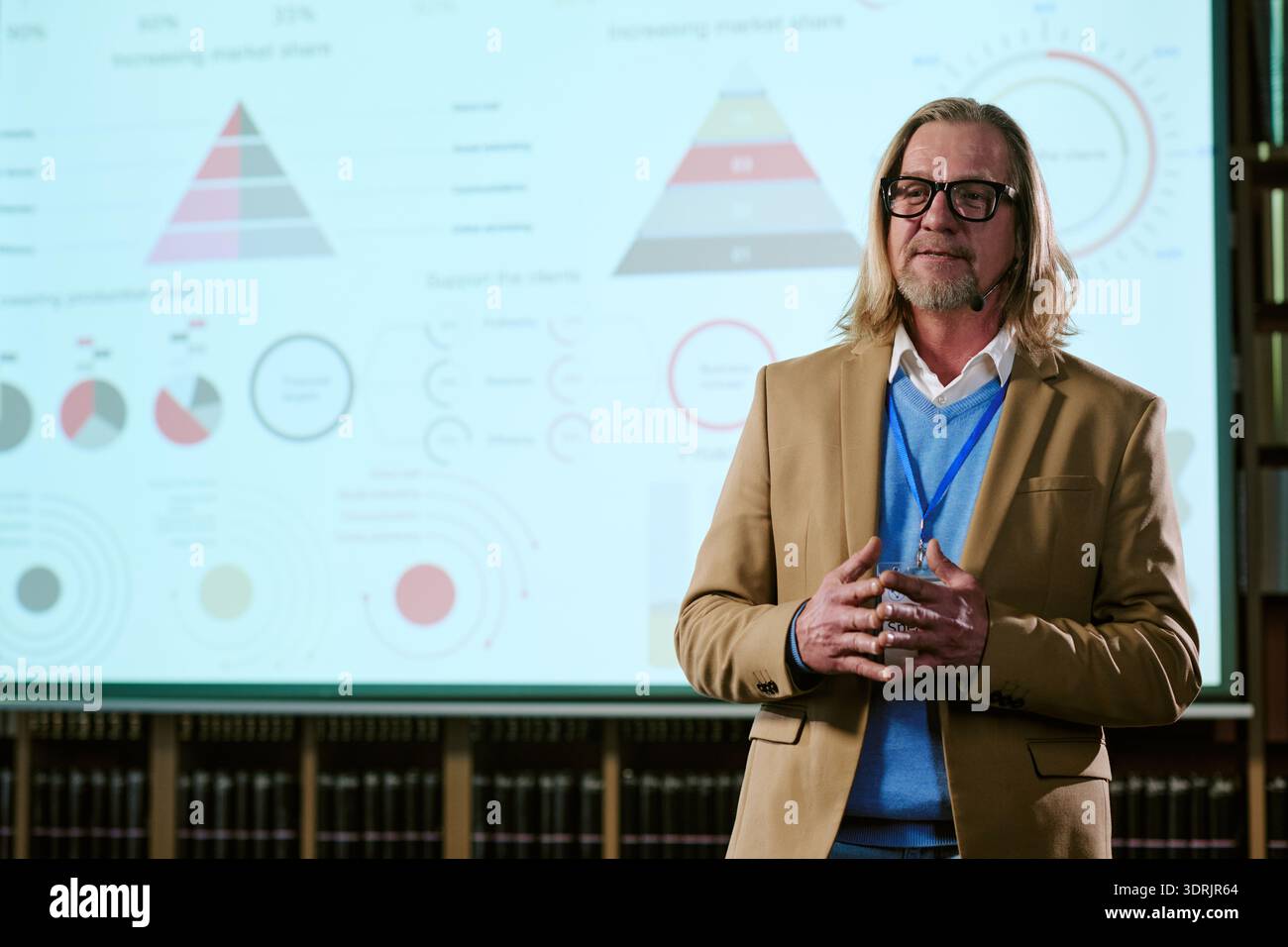 Middle Aged Caucasian Man Giving Business Presentation with Infographics Stock Photo