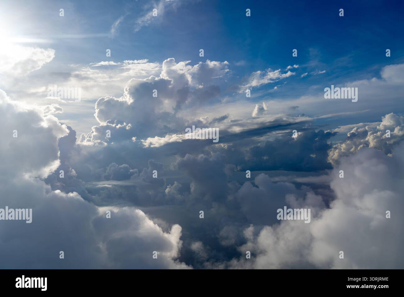 Dramatic sky with sunbeams and clouds seen from an airplane Stock Photo