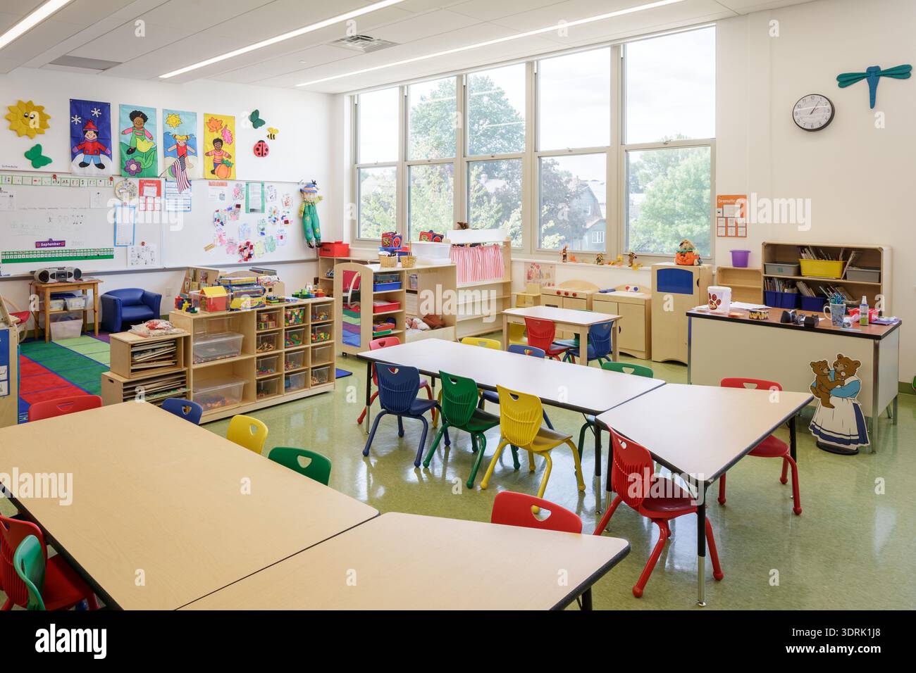 Interior of a modern, brightly lit elementary school classroom with ...