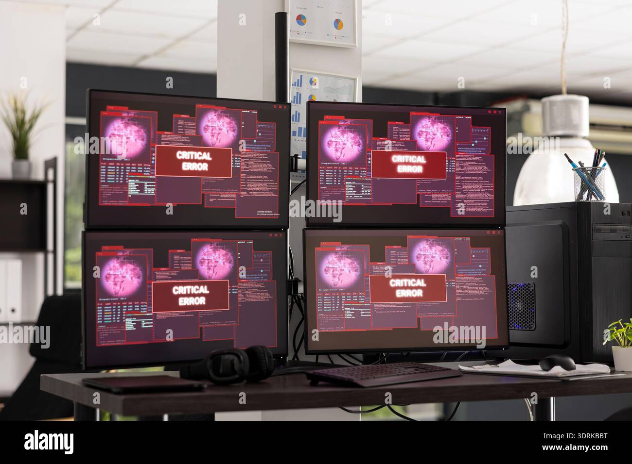 Desktop monitors show system error warnings in empty office workspace. The scene represents software failure, technical issues and business interruption in modern IT environment. Stock Photo