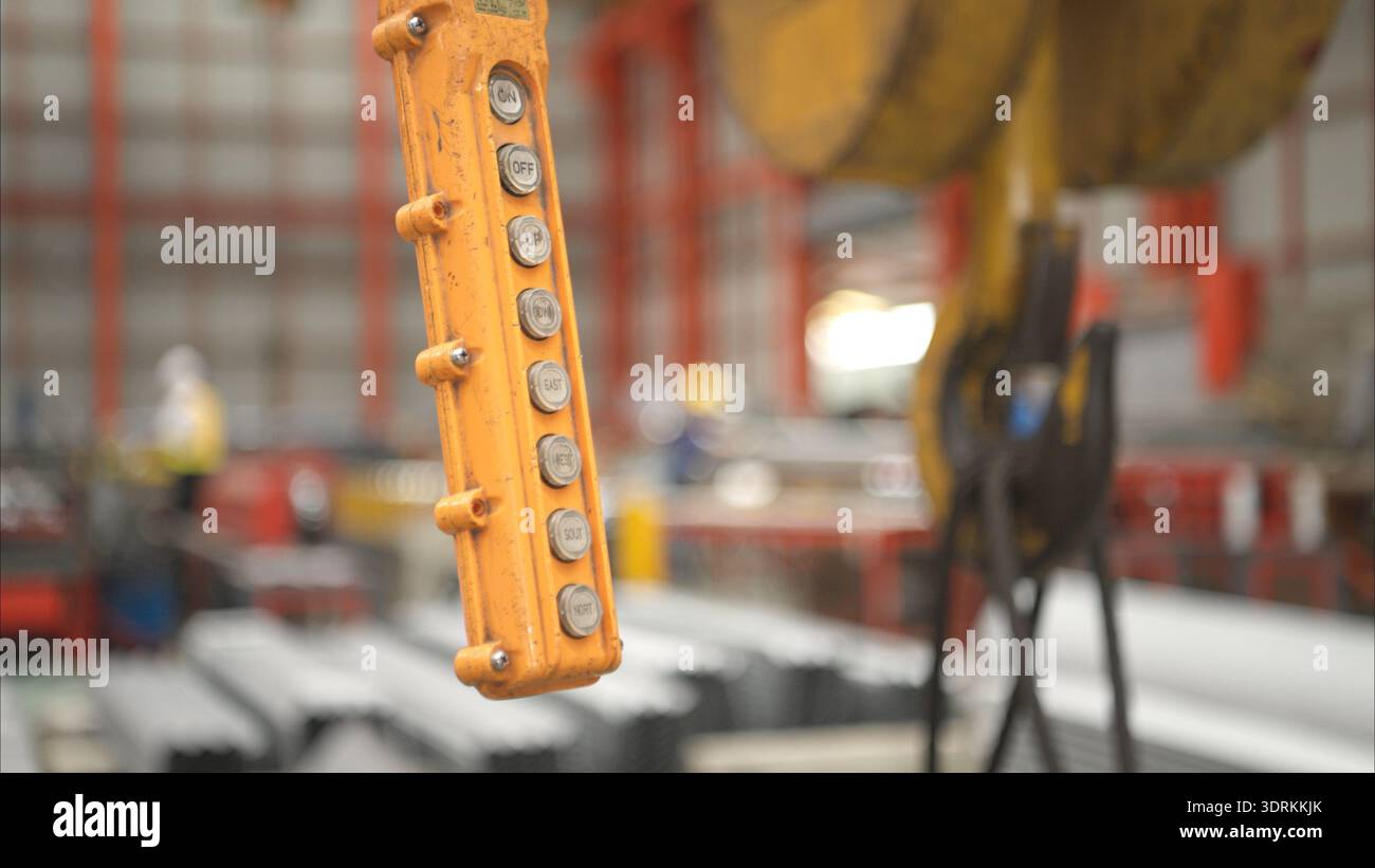 Close-up of industrial crane control panel with directional buttons inside a manufacturing warehouse Stock Photo