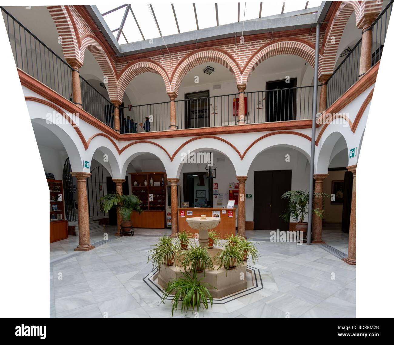 Panoramic view of an Andalusian courtyard with arches, columns, and a central fountain at the Museo de Osuna in Osuna, Andalusia, Spain. Stock Photo