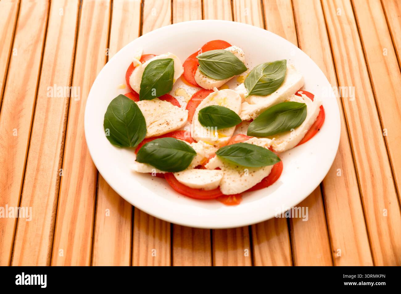 Plate with mozzarella, tomatoes and basil Stock Photo