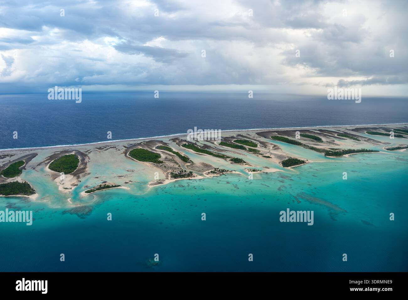 Aerial view of Rangiroa atoll, French Polynesia, with lagoon and cloudy ...