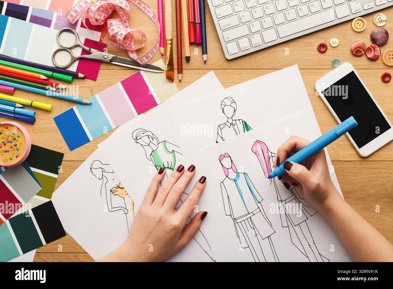 Creative Process in a Fashion Design Studio With Sketches and Materials on a Workspace Stock Photo