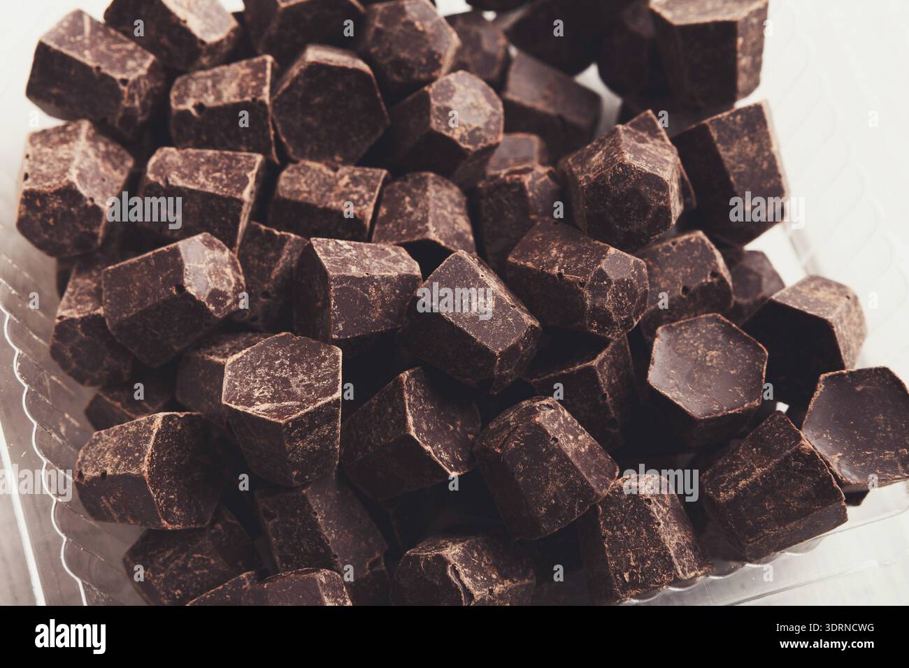 Tasty chocolate chips pile, closeup on white background Stock Photo