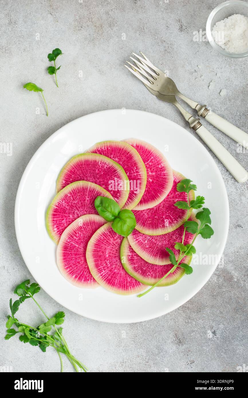 Sliced watermelon radish on white plate Stock Photo