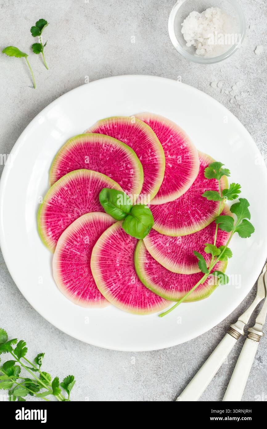 Sliced watermelon radish on white plate Stock Photo