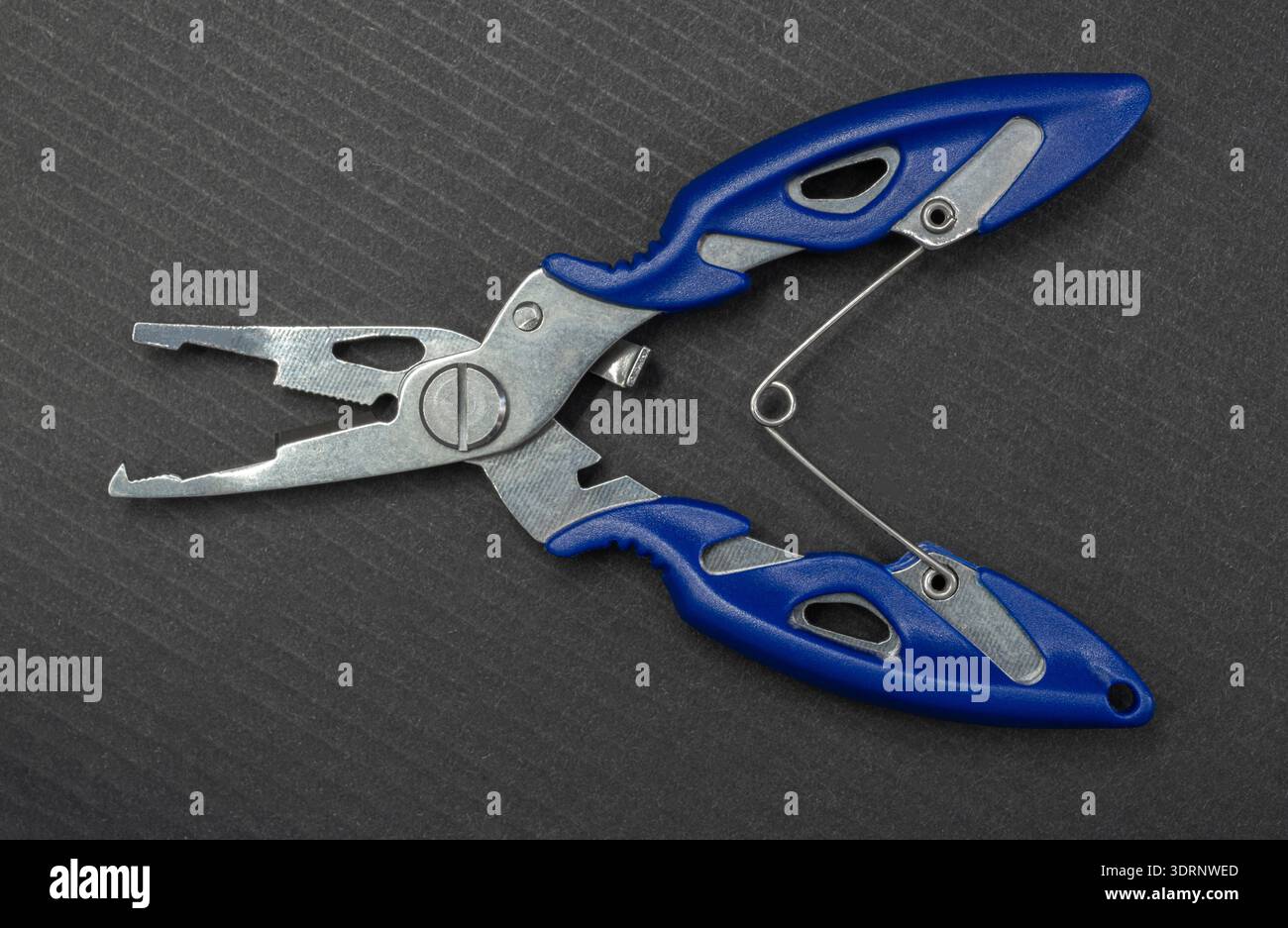 Fishing multitool close-up on a black background Stock Photo