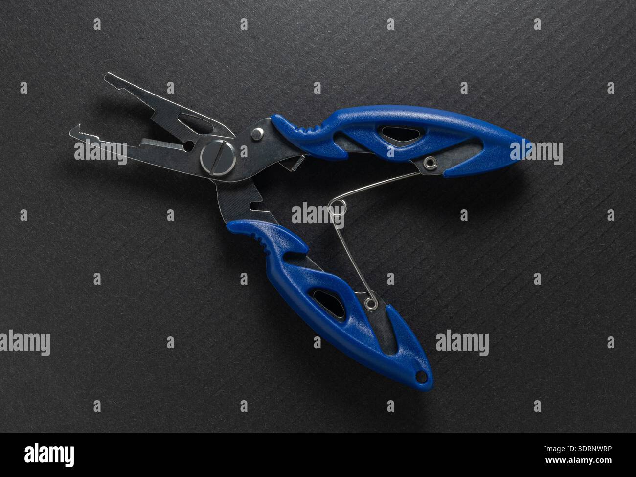 Fishing multitool close-up on a black background Stock Photo