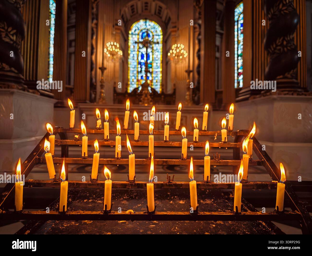 Votive candles in front of a window with a cross, Saint Paul's Cathedral, London, England, Great Britain, Europe Stock Photo