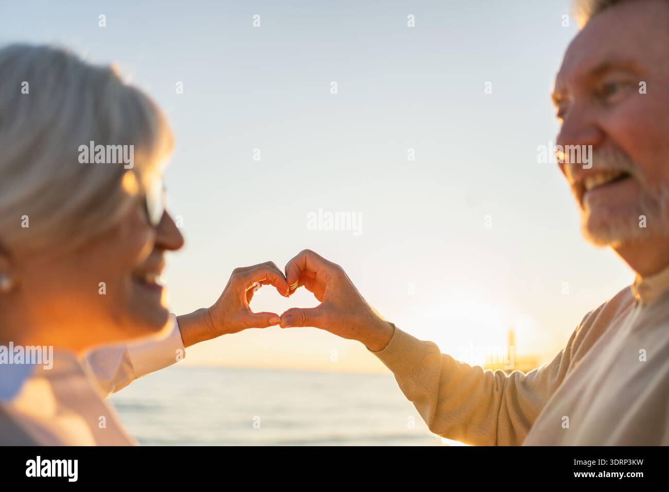 Love heart shape peace. Senior older couple making heart shape with ...