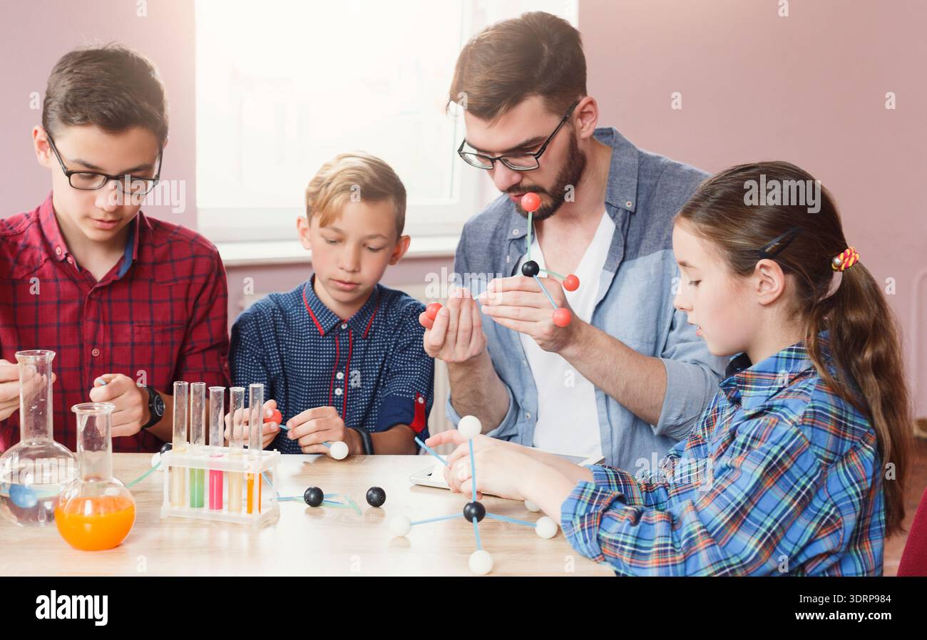 Students Learn About Molecules Through Hands-On Activity in a Classroom Setting Stock Photo