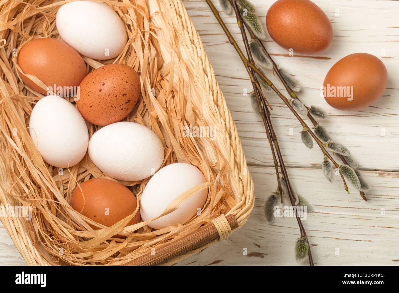 White and brown eggs in the basket on the table. Easter Stock Photo