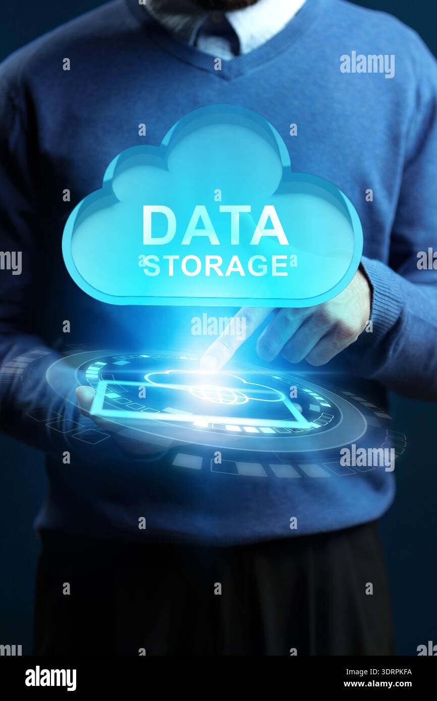 Person interacts with digital cloud symbol for data storage at an office setting Stock Photo