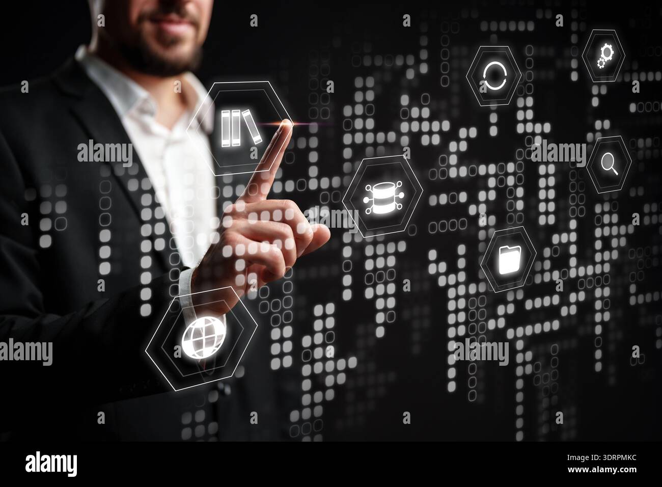 Businessman interacts with digital interface showing data and technology symbols Stock Photo