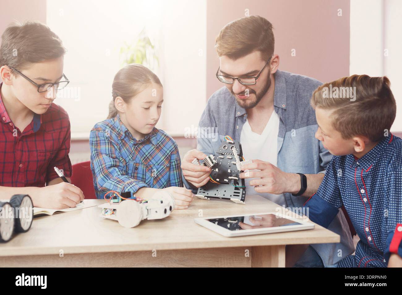 Students Learn About Robotics and Engineering Through Hands-On Project Work in a Classroom Setting Stock Photo