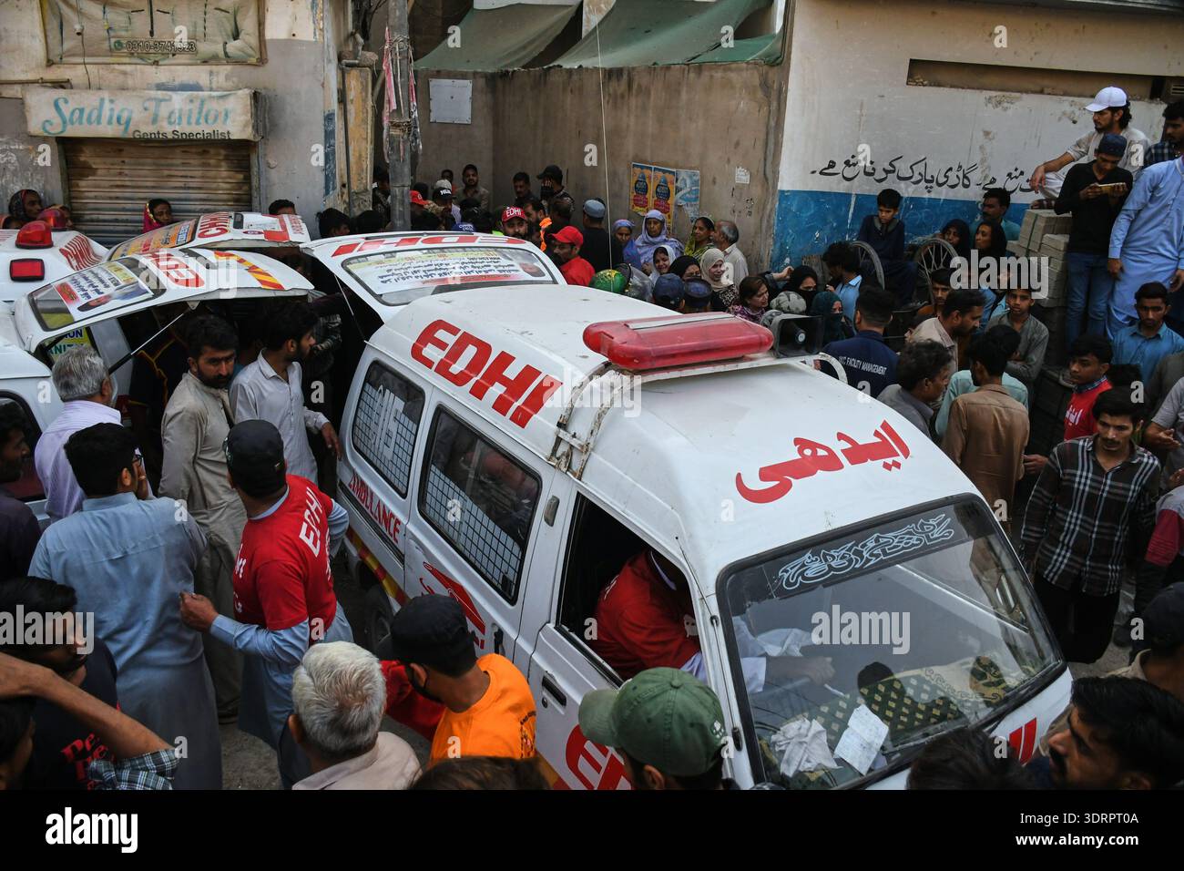 Rescue workers load a body into an ambulance after recovering it from ...