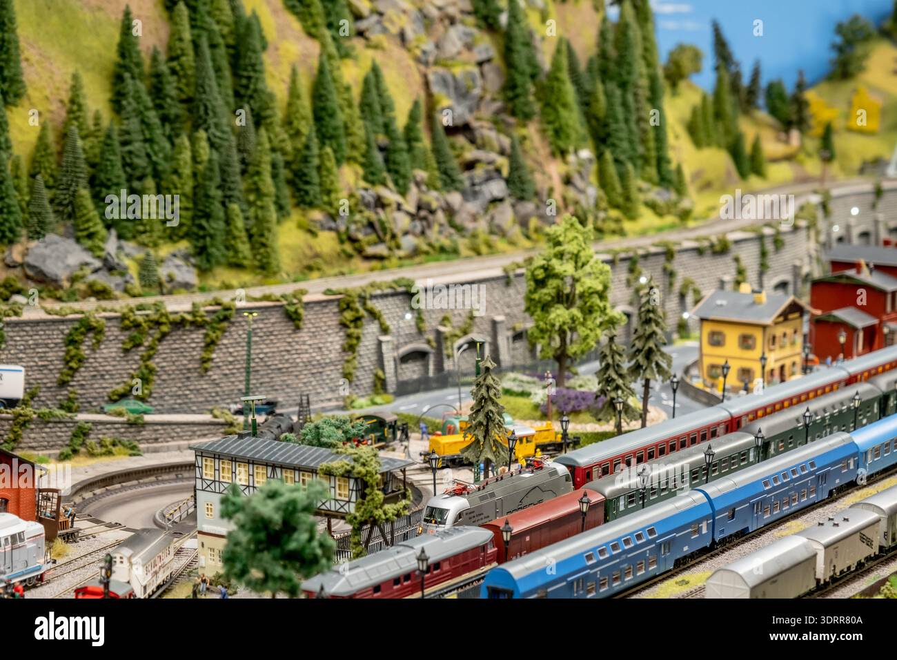 a detailed and colorful model train layout depicting a small railway ...