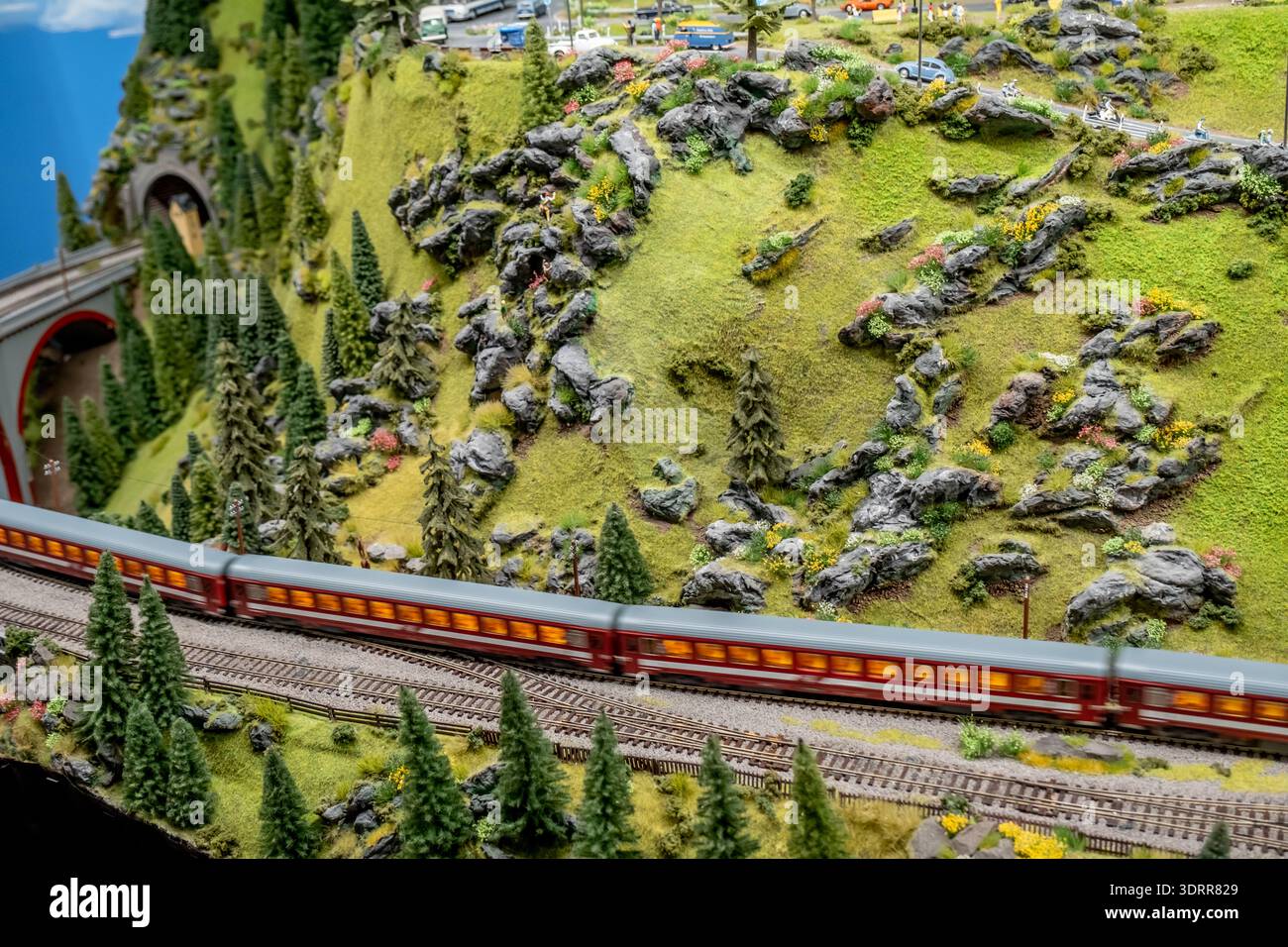 a detailed and colorful model train layout depicting a small railway ...