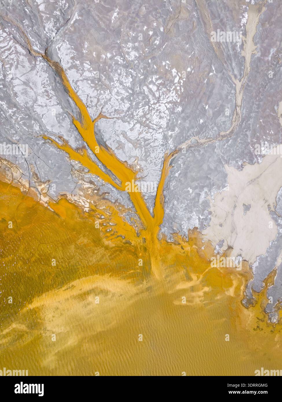 Color Against Aerial view of ochre waters flow, staining the landscape with veins of ...