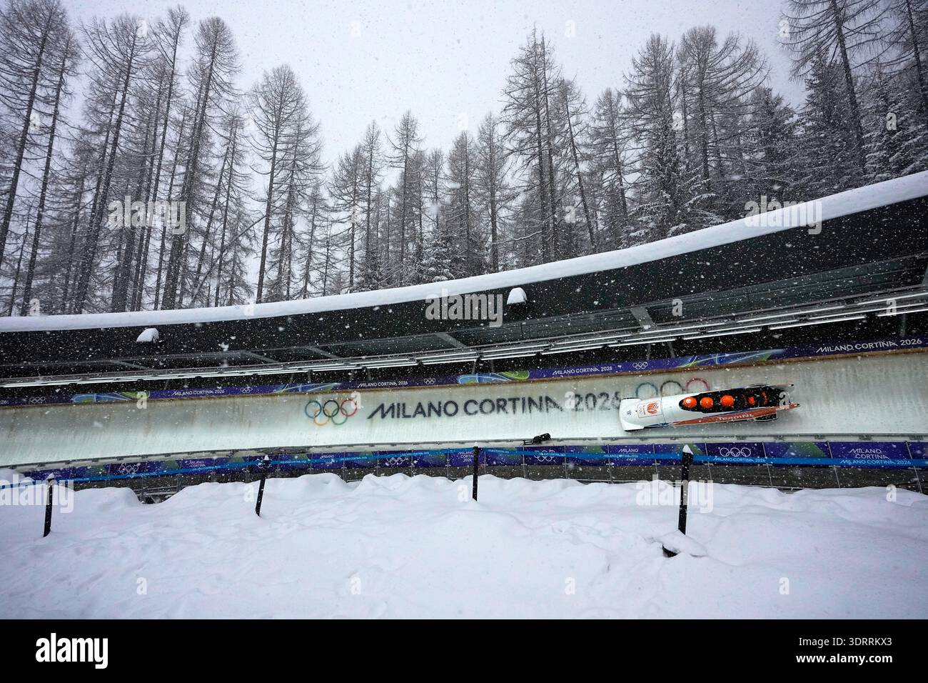 Netherlands' Dave Wesselink, left, slides down the track during a four ...