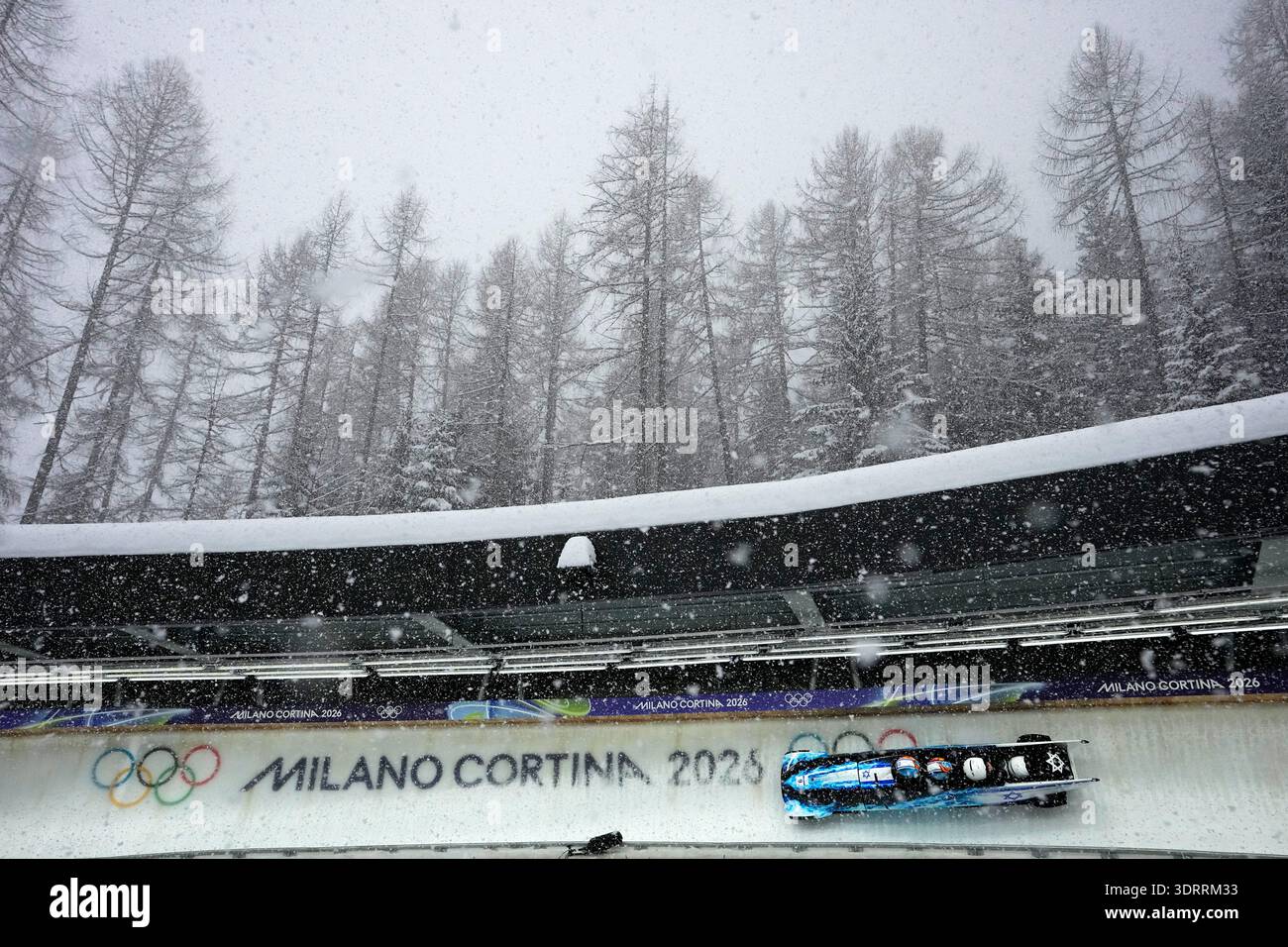 Israel's Adam Edelman, left, slides down the track during a four man ...