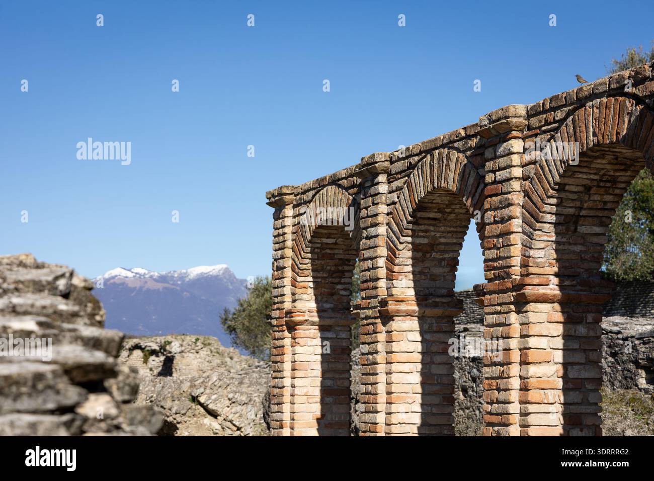 Ancient Roman ruins with brick arches and stone walls in Northern Italy ...