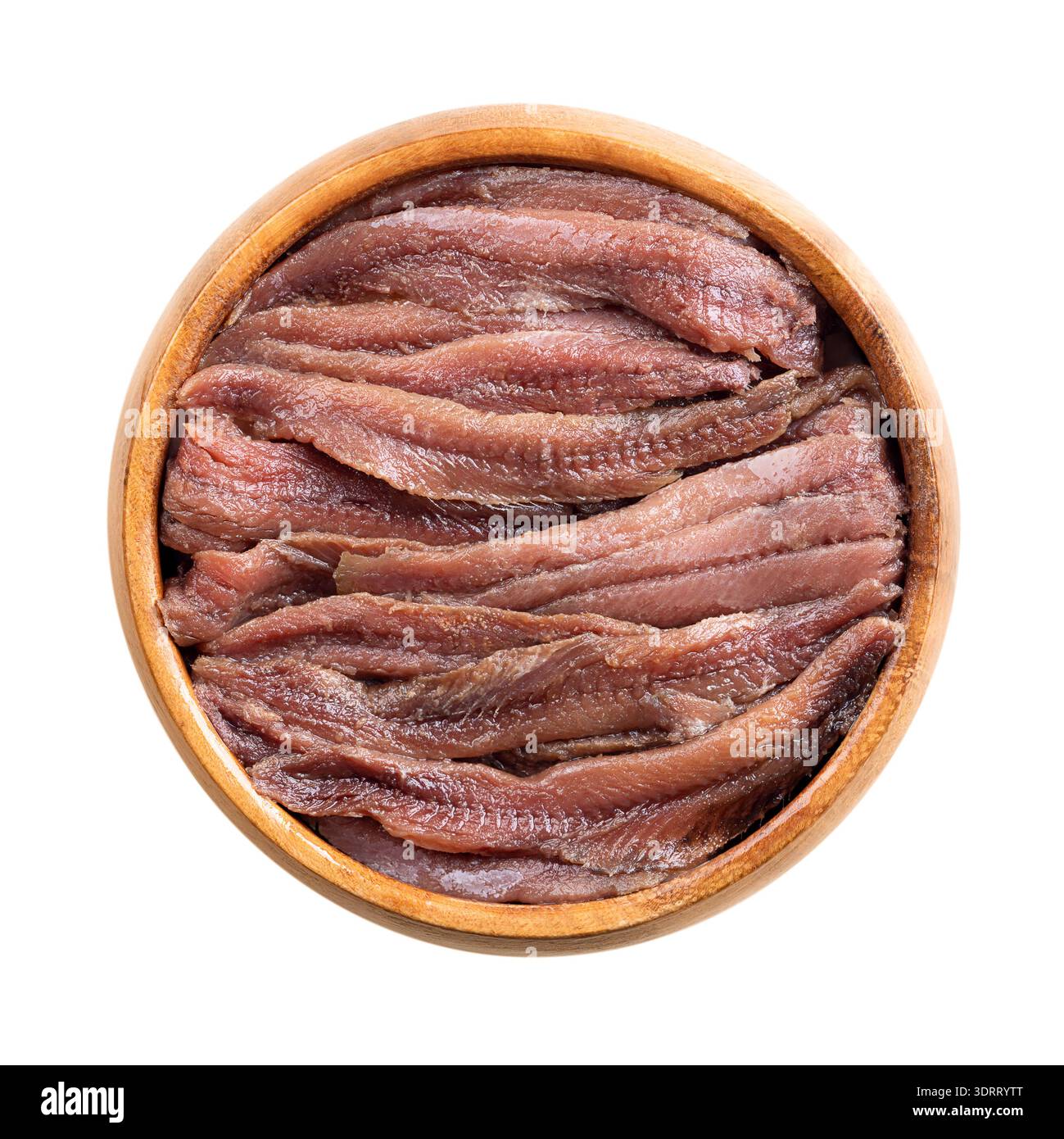 Anchovy fillets in vegetable oil in wooden bowl. Salted fillets from Peruvian anchoveta, Engraulis ringens, a small saltwater forage fish. Stock Photo