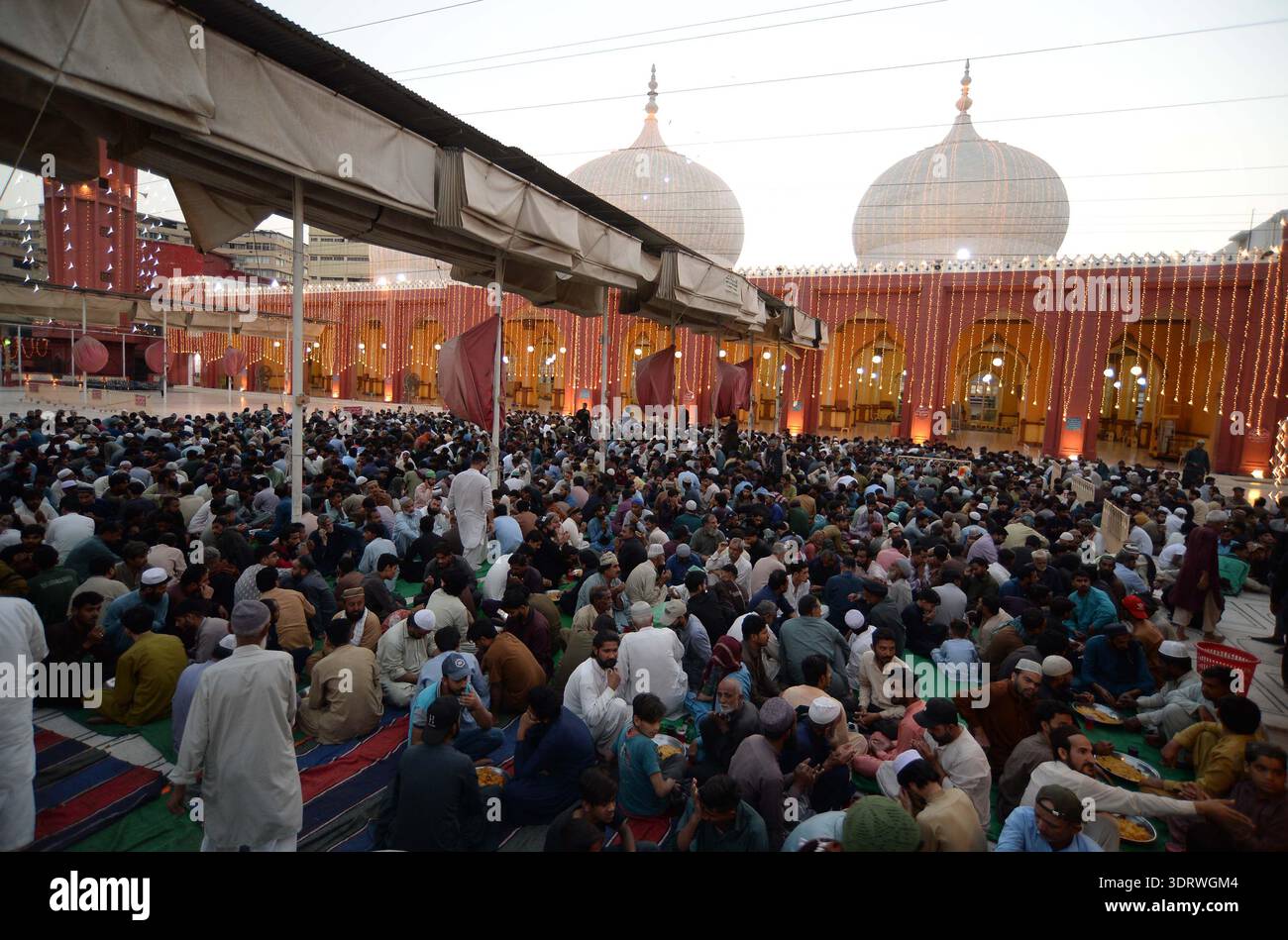 Faithful Muslims are breaking the fast (Iftar) on the first day of the ...