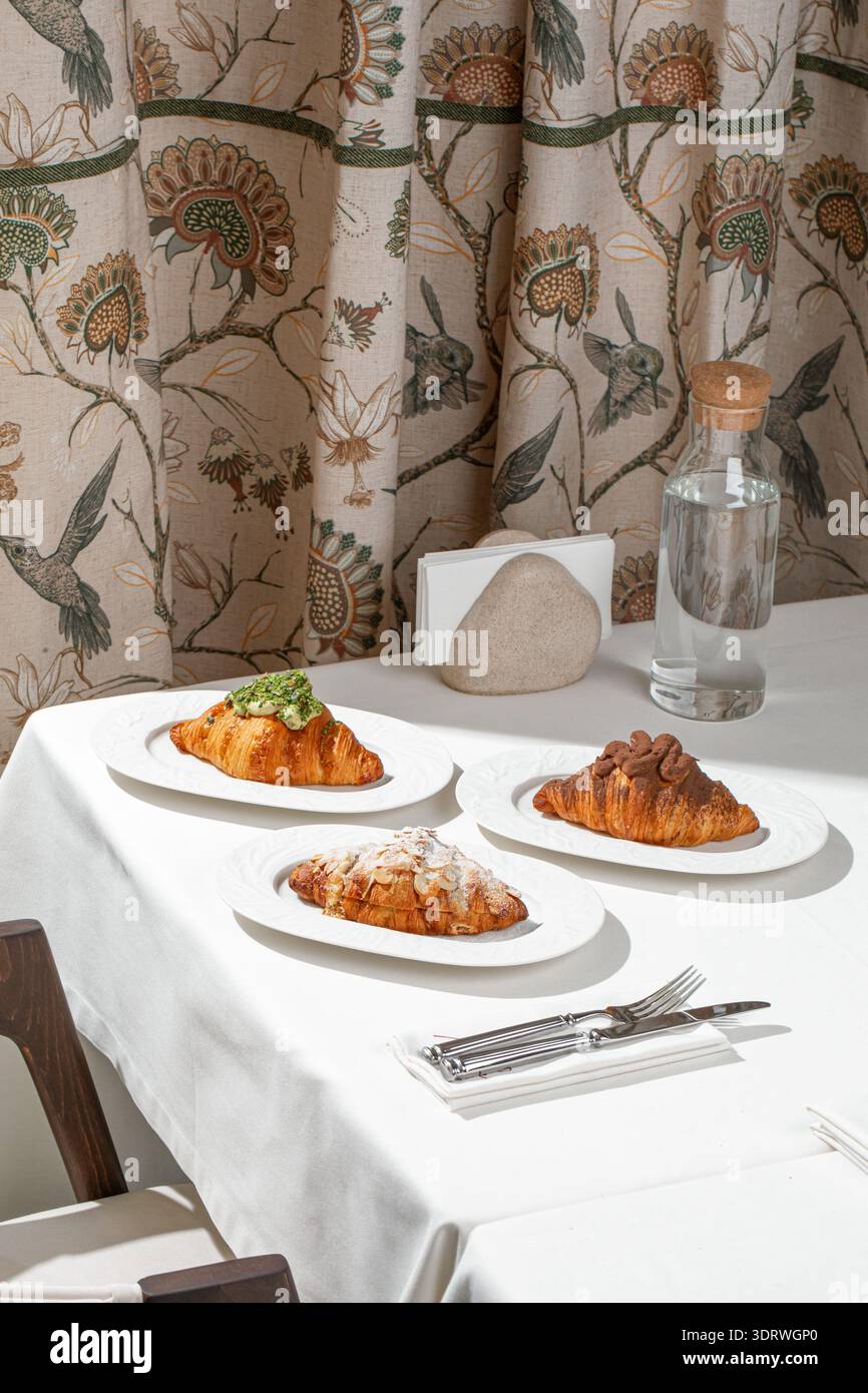 Assorted croissants served in cozy cafe Stock Photo