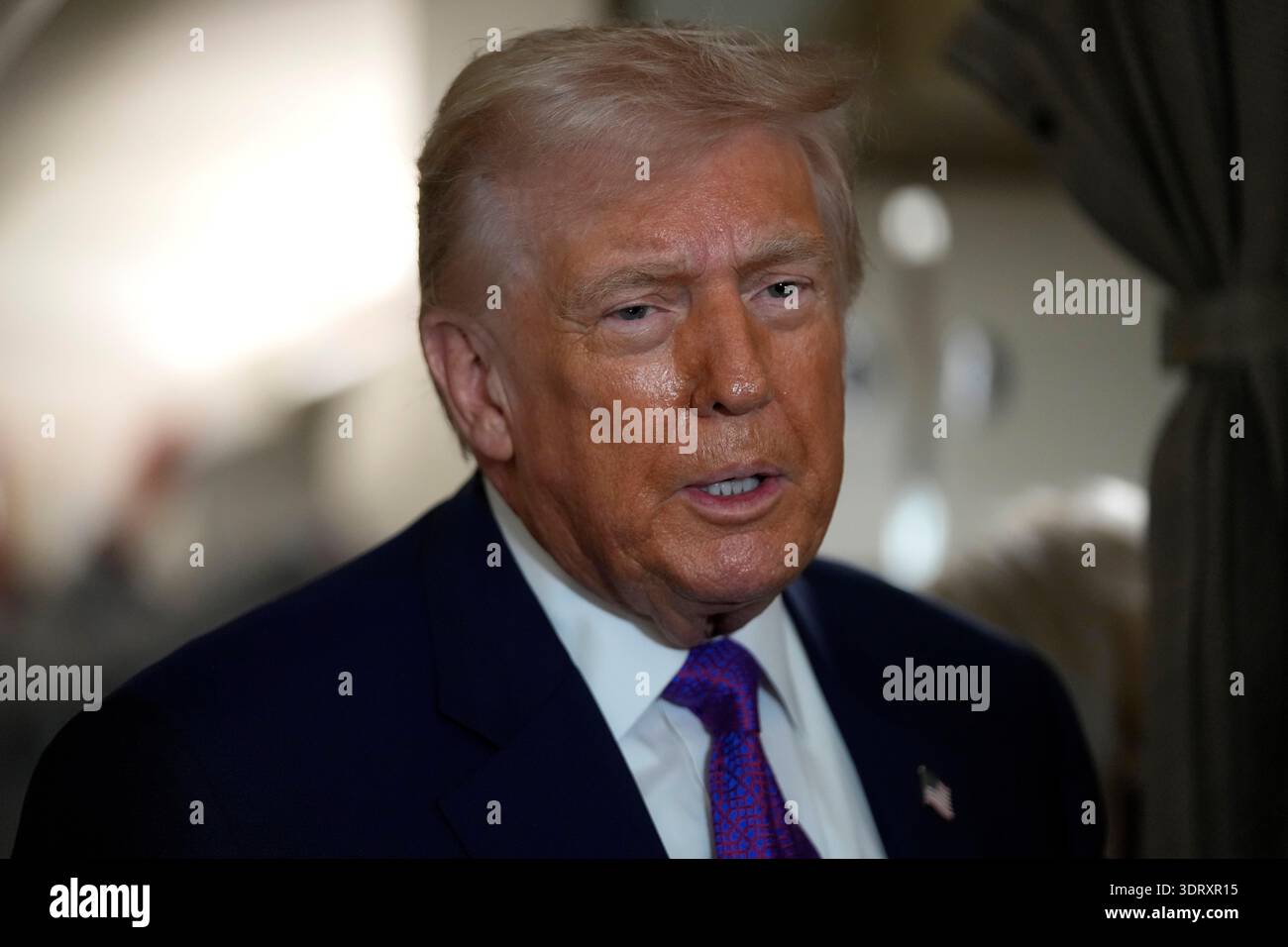 President Donald Trump speaks to reporters aboard Air Force One shortly ...
