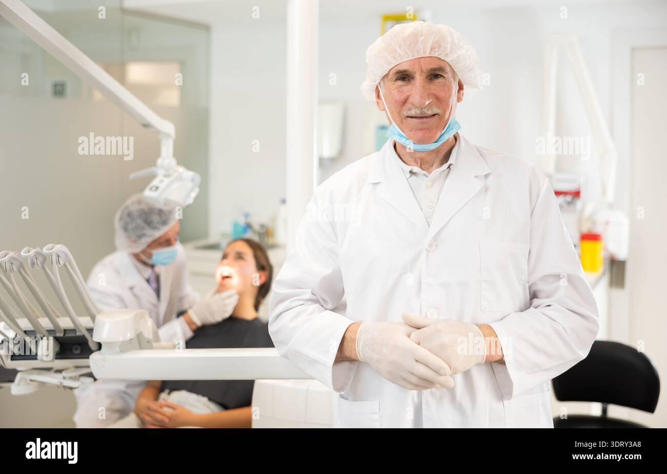 Senior man doctor is standing in dental office, clinic Stock Photo