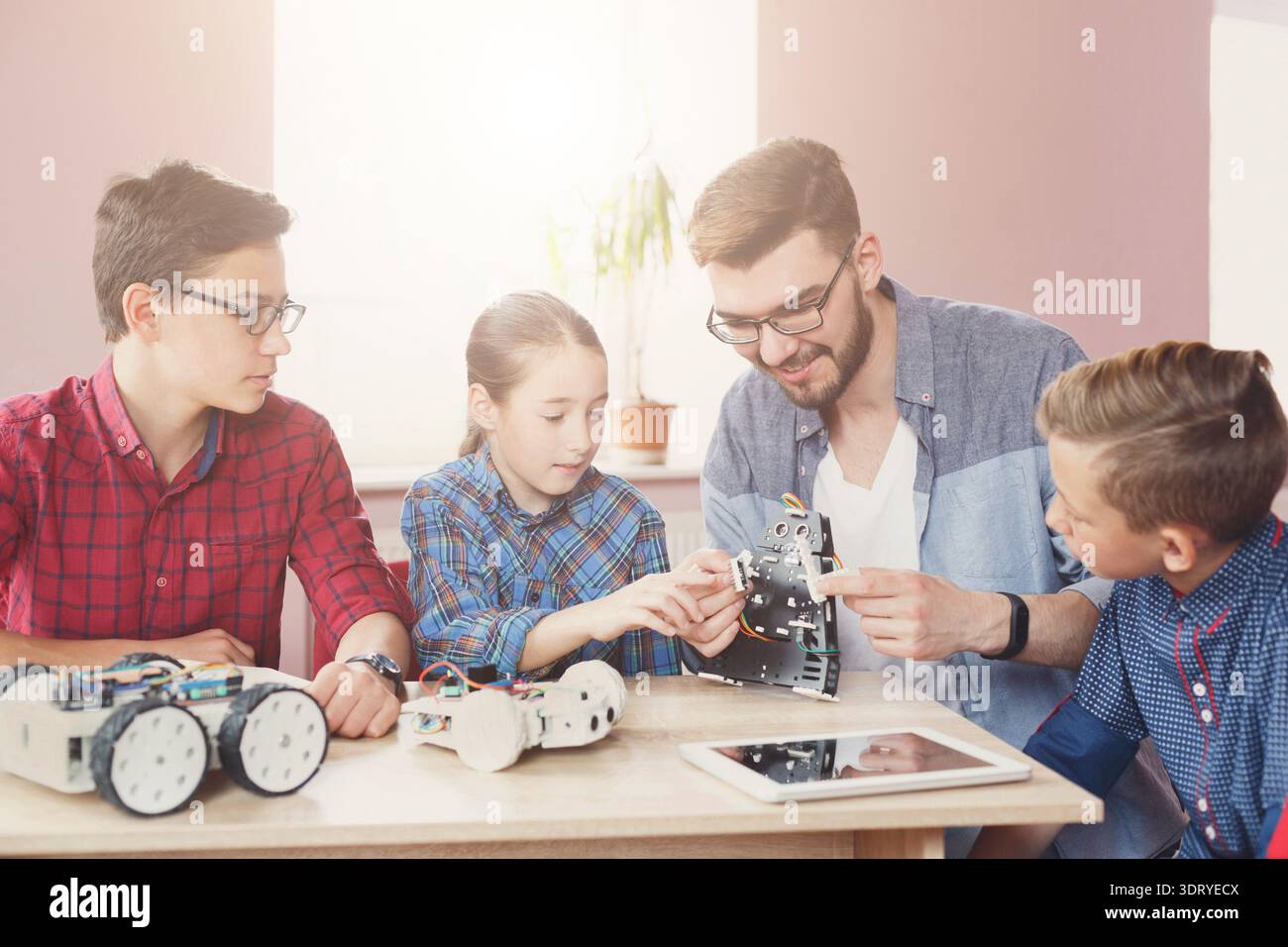 Students Learn Robotics Skills With Teacher During a Technology Class ...