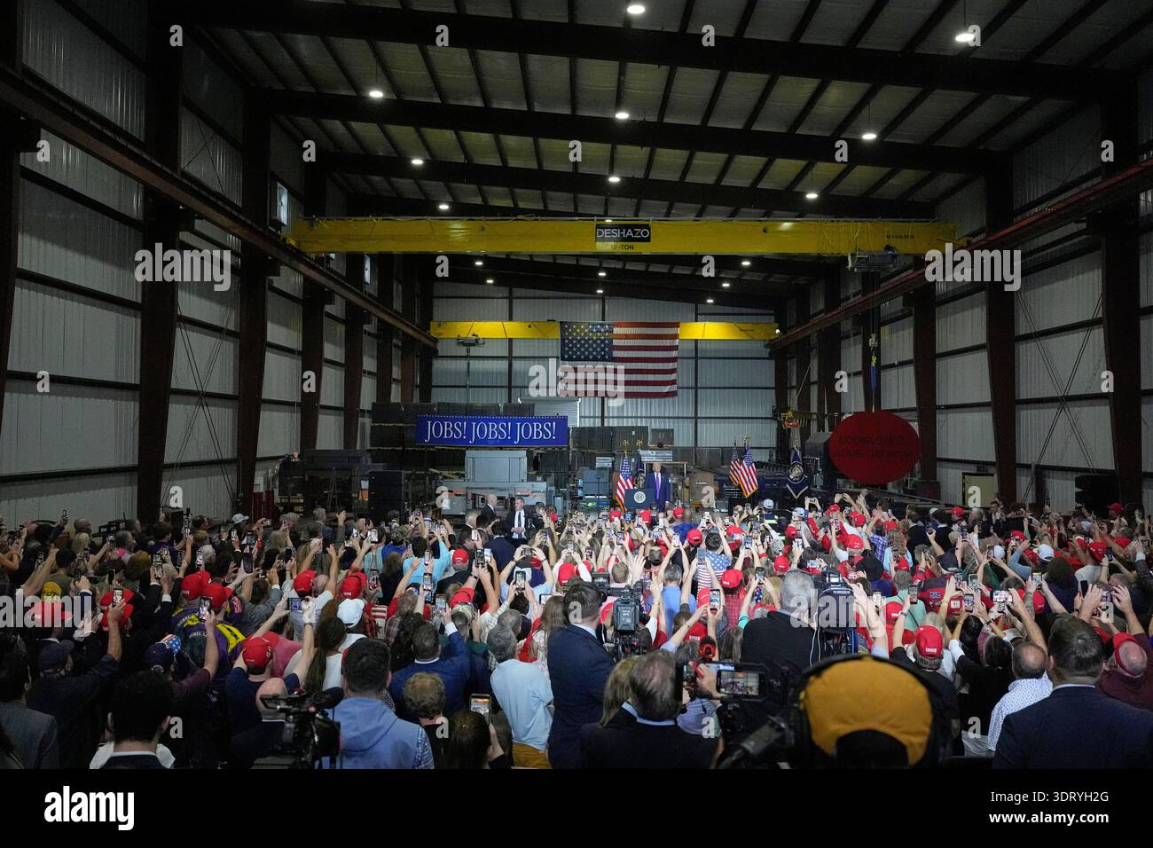 A crowd cheers President Donald Trump's arrival at a rally at Coosa ...