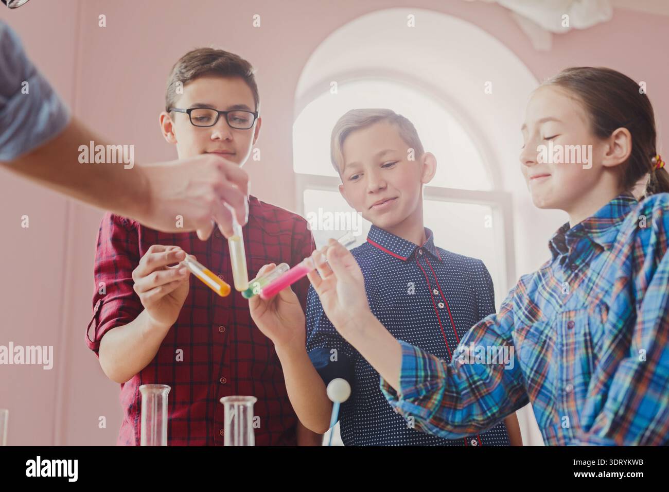 Children Conduct Experiments With Test Tubes in a Classroom Setting ...