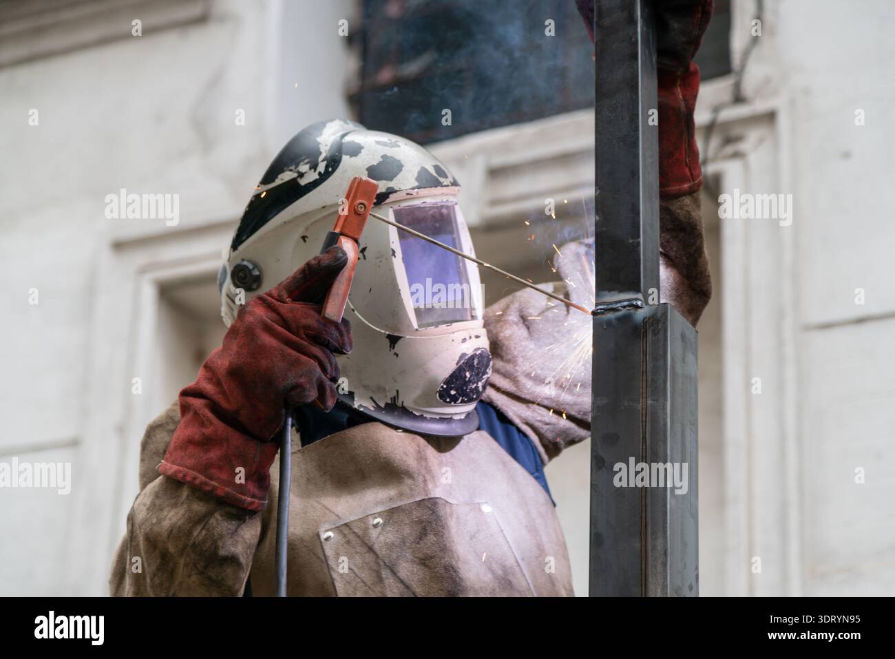 Welder working with protective gear, arc welding metal Stock Photo
