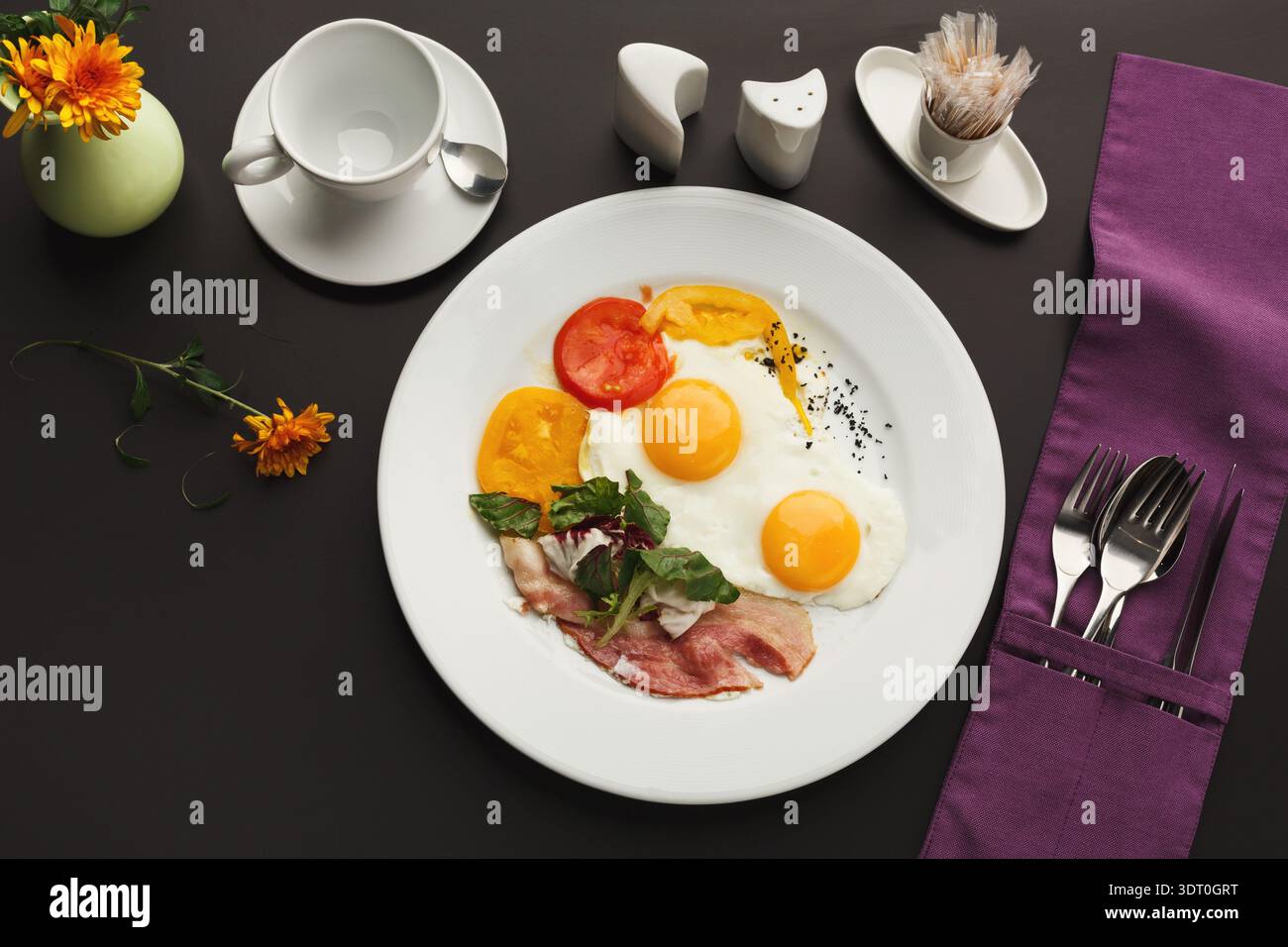 Delicious Breakfast Collection With Eggs, Vegetables, and Sides on a Table Setting Stock Photo