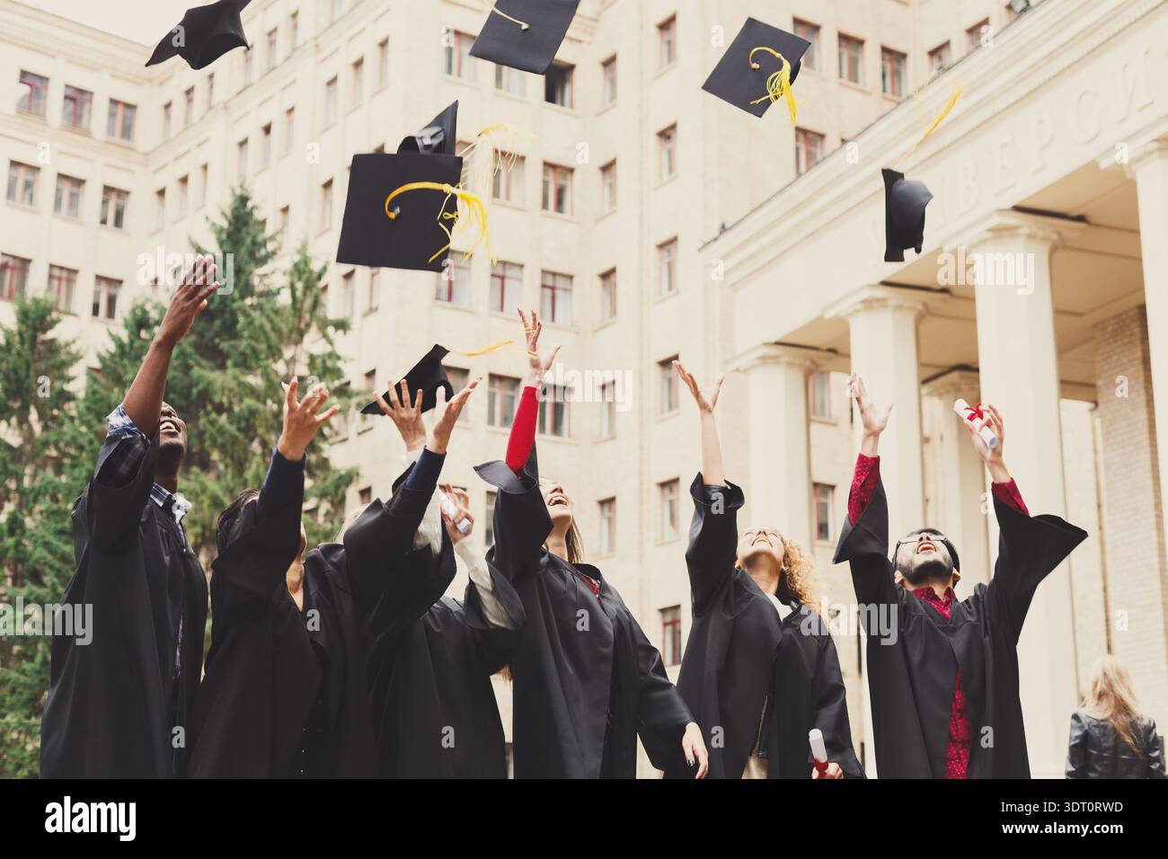 Graduation Ceremony With Students Celebrating and Throwing Caps in the ...