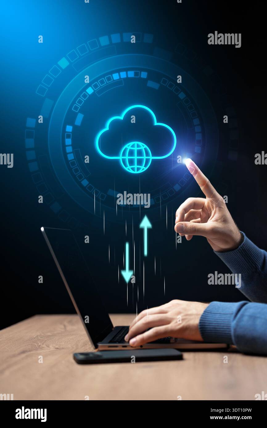 Person using laptop to upload data to cloud storage in digital workspace Stock Photo