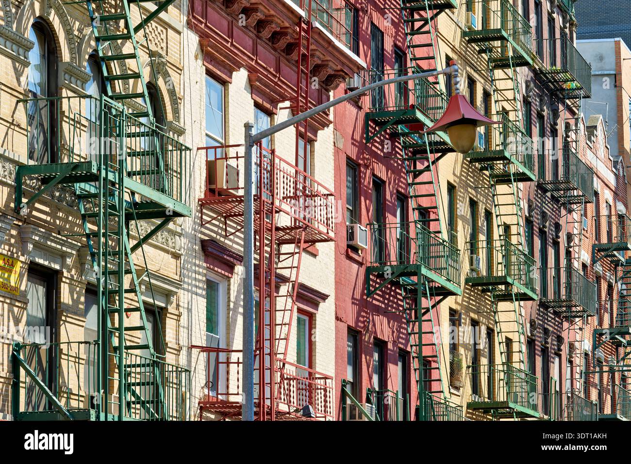 In Manhattan, fire escape stairs line the buildings. These structures provide safety access for residents. Stock Photo