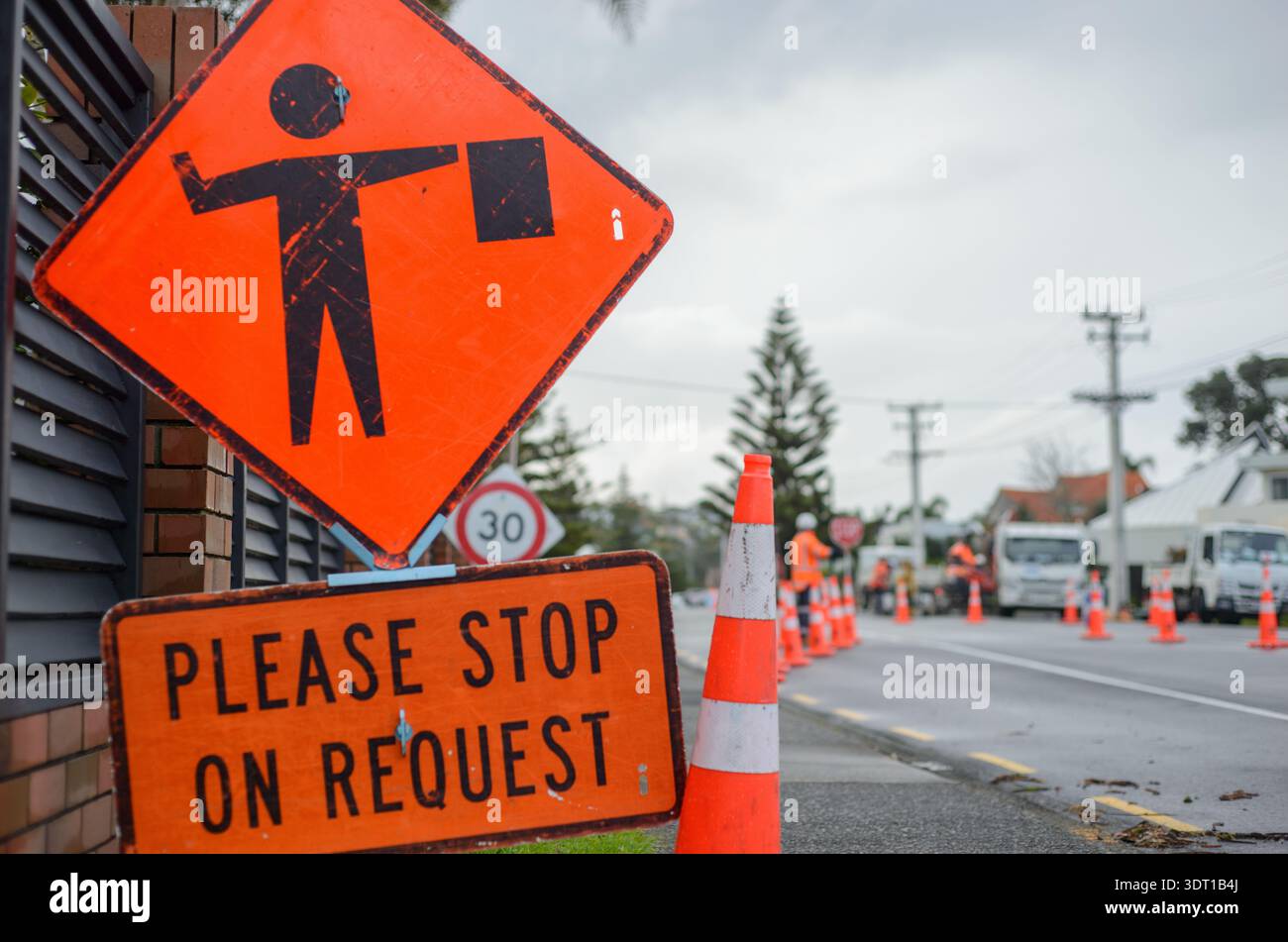 Stop Please Sign In Please Stop on Request road sign by the road. Unrecognizable workers ...
