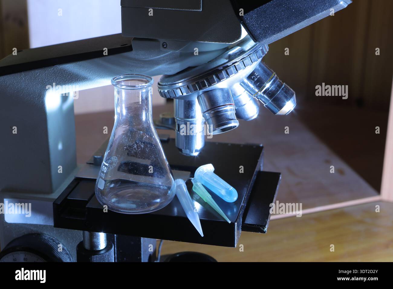 Microscope observing samples in a scientific laboratory setting with blue light Stock Photo