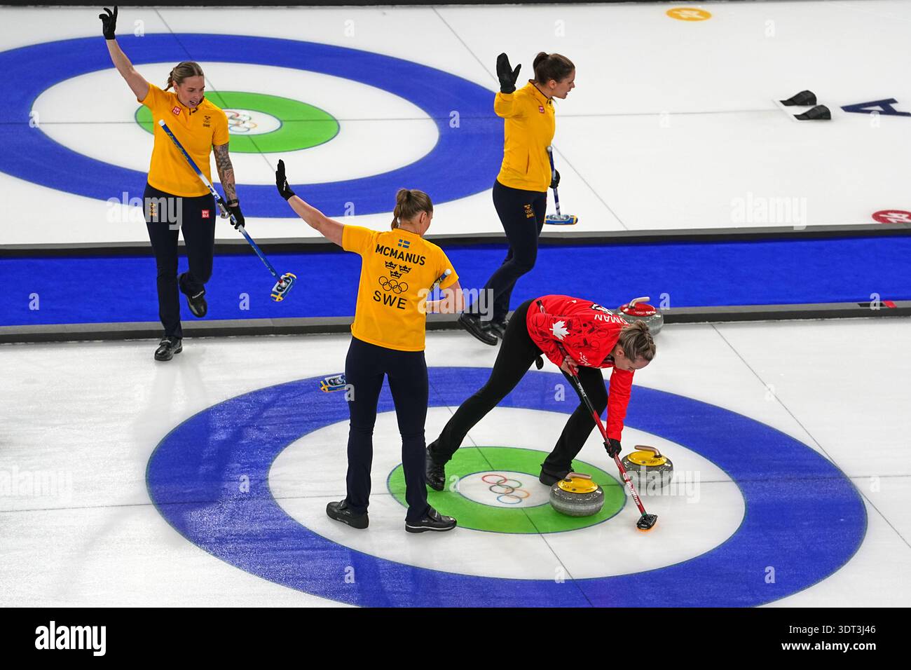 Canada's Rachel Homan, right, competes next to Sweden's Sara McManus ...