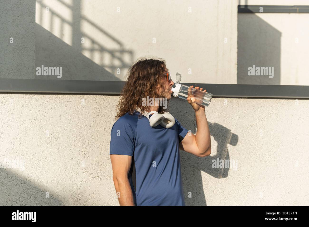 Man drinking water after workout outdoors Stock Photo