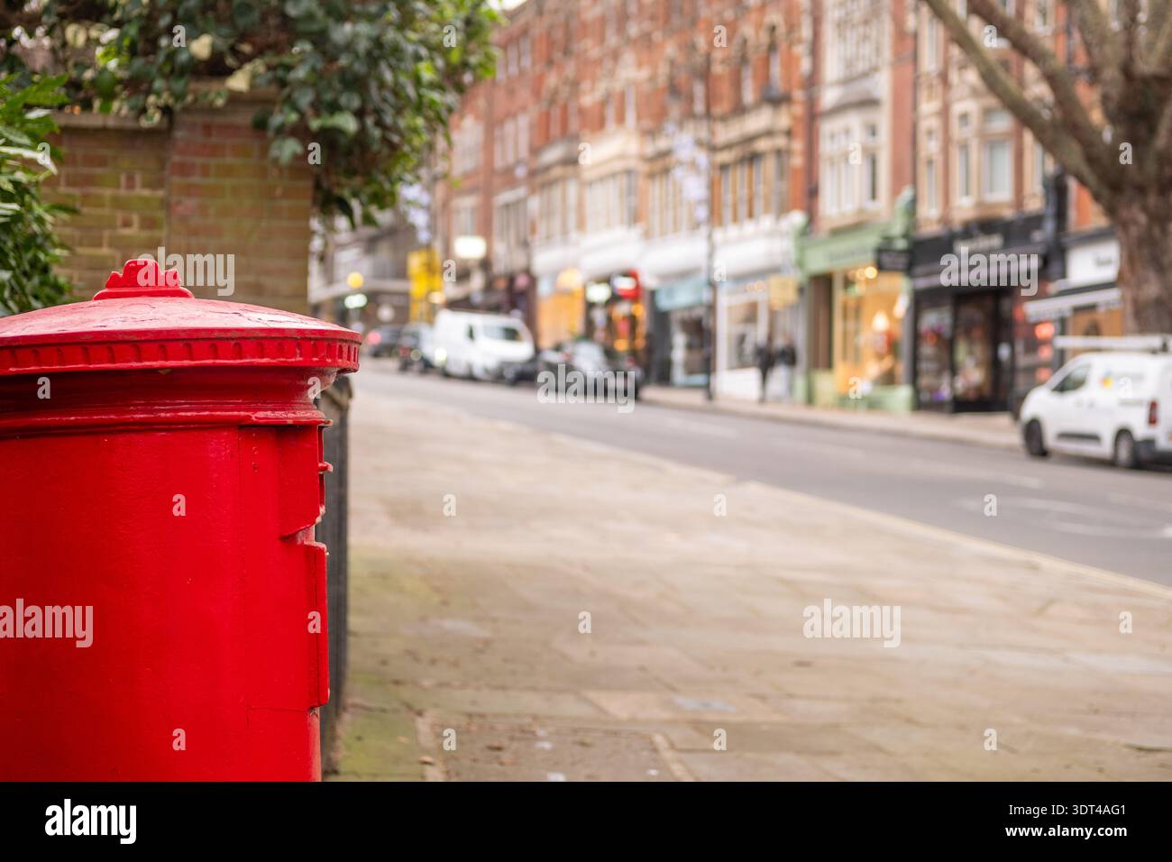 Red British Post Box  on Hampstead London high street. Traditional UK Street Scene Stock Photo
