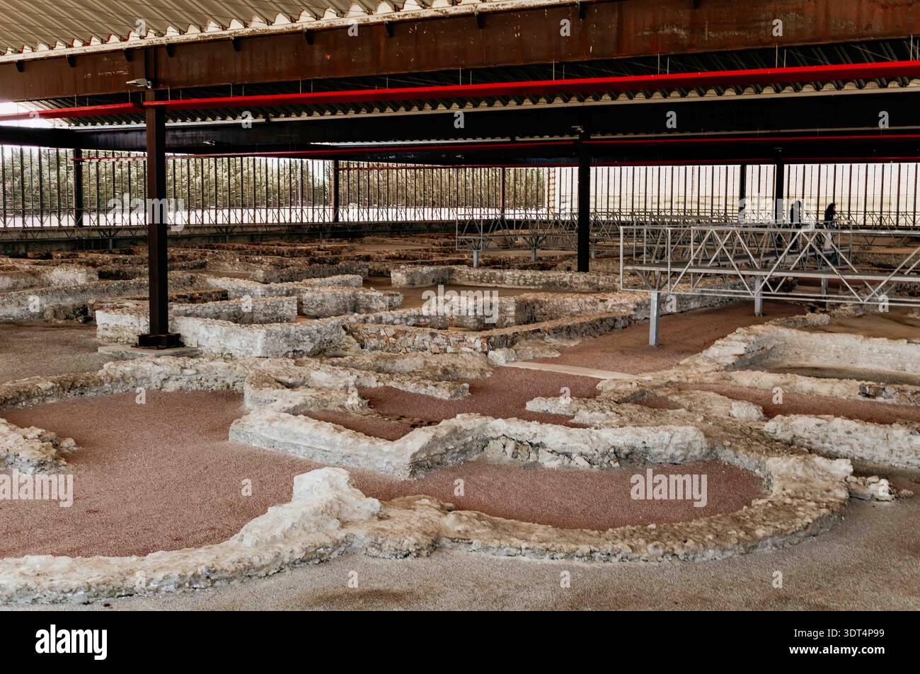 Past Structures Workers and visitors explore the remains of ancient structures at an ...