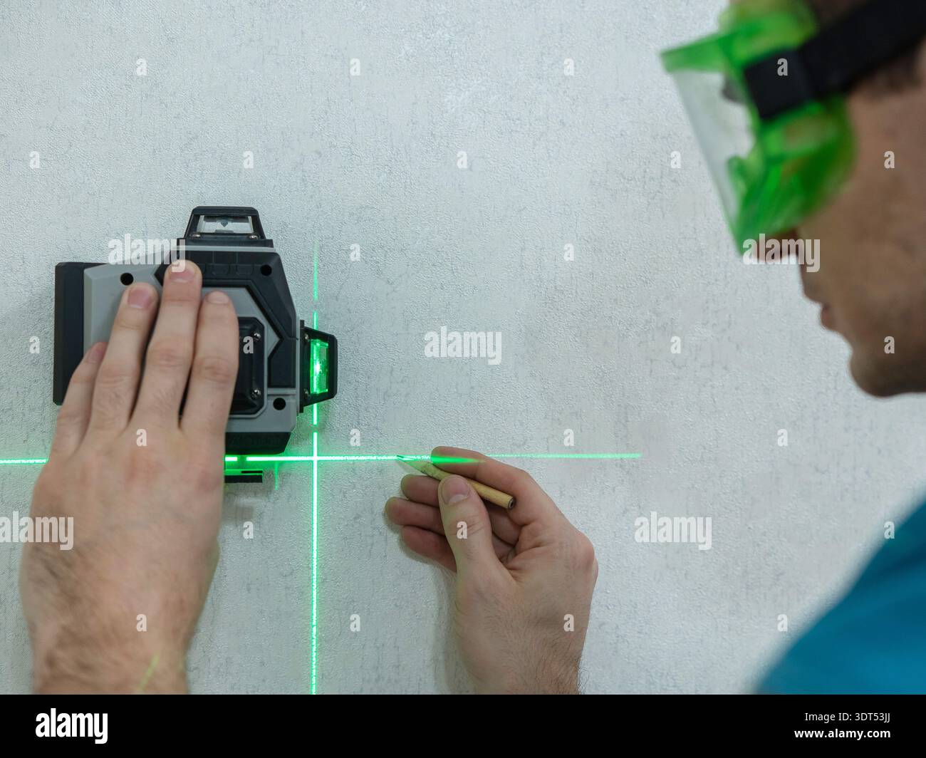 A man measures distance with a laser level.  Stock Photo