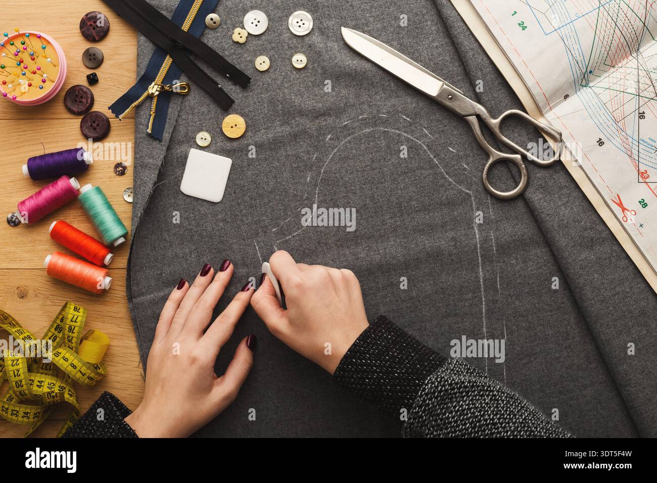 Crafting a Custom Garment With Fabric, Tools, and Colorful Threads for Sewing Projects Stock Photo